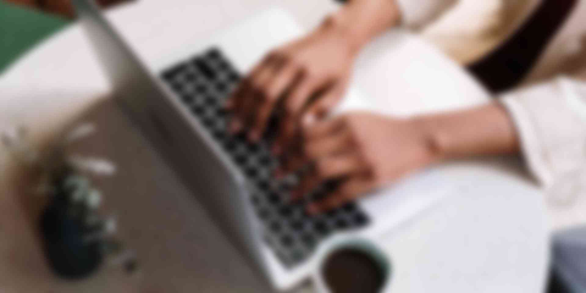 How to close your email messages - overhead-shot-of-hands-typing-on-laptop