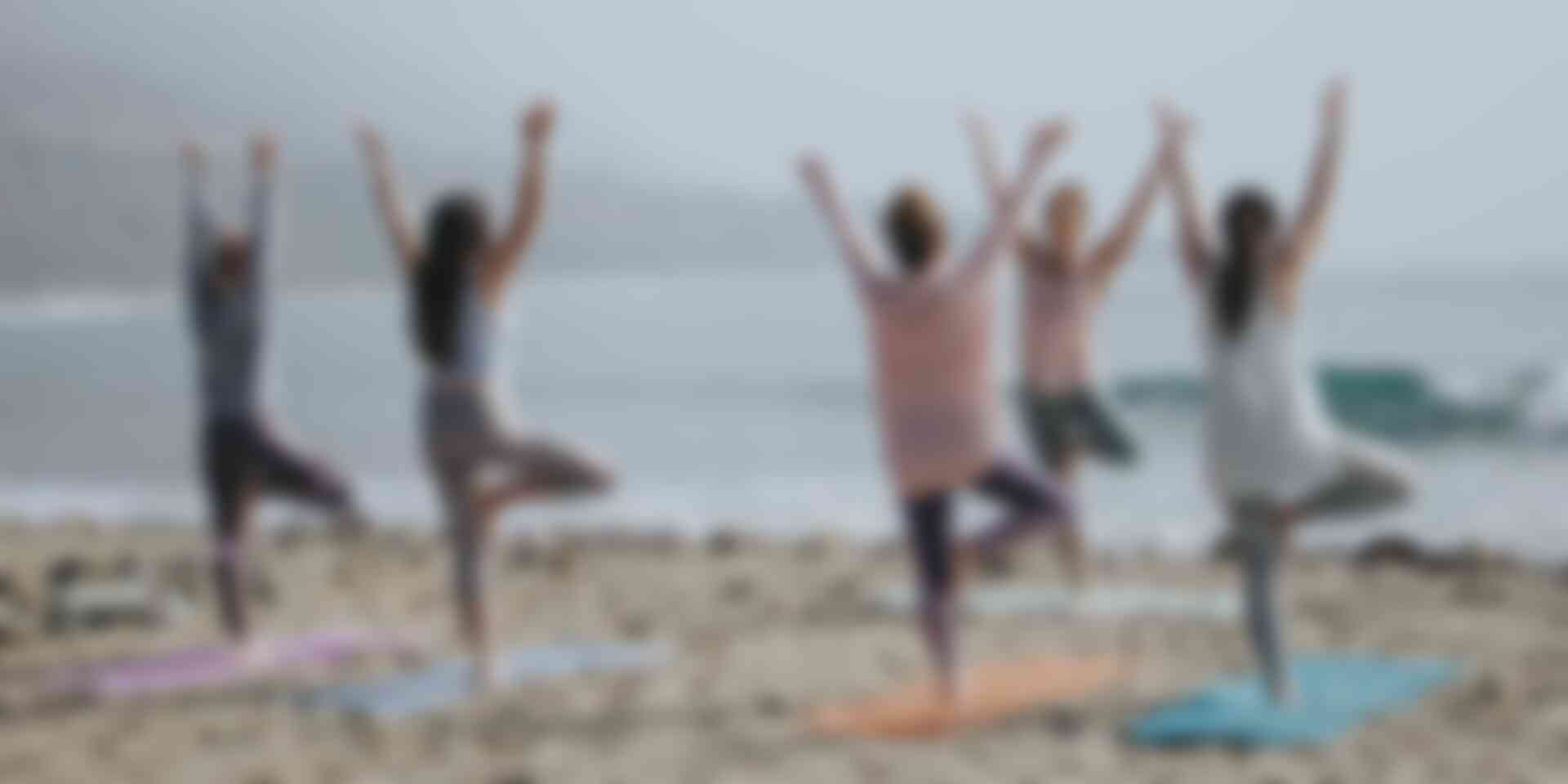 How yoga can improve your presentation skills - women-doing-yoga-on-beach