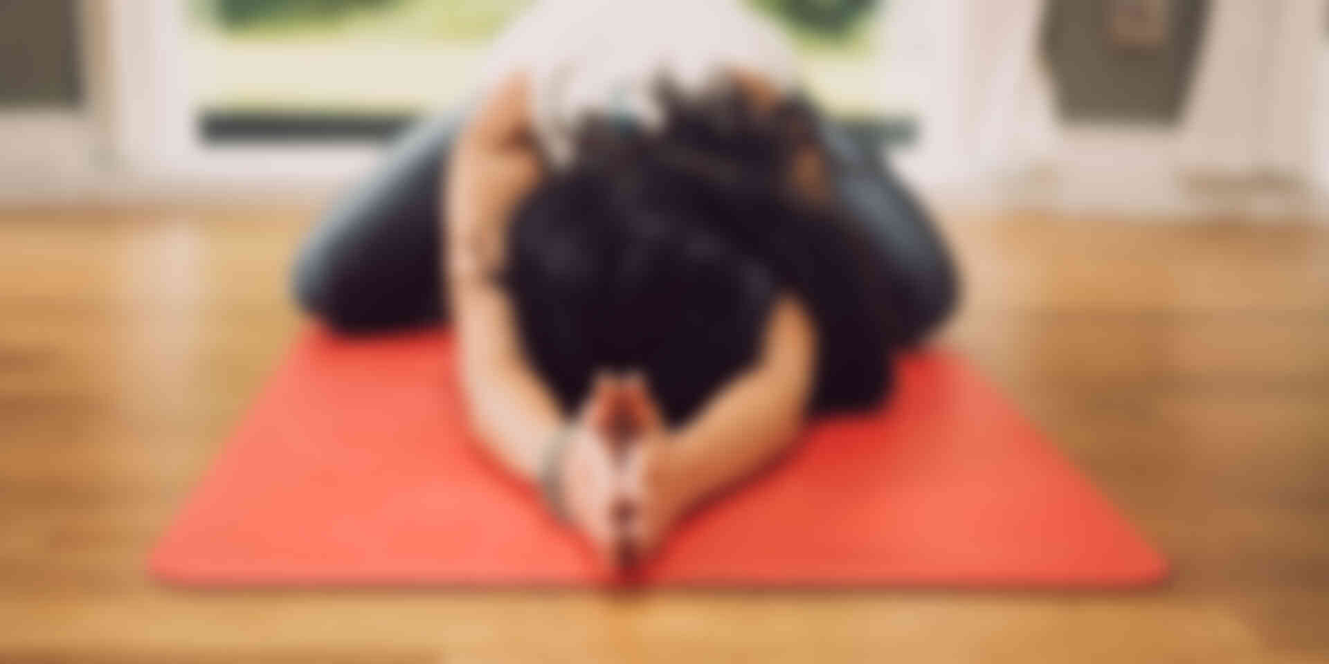 How yoga can improve your writing skills - woman-doing-yoga-living-room