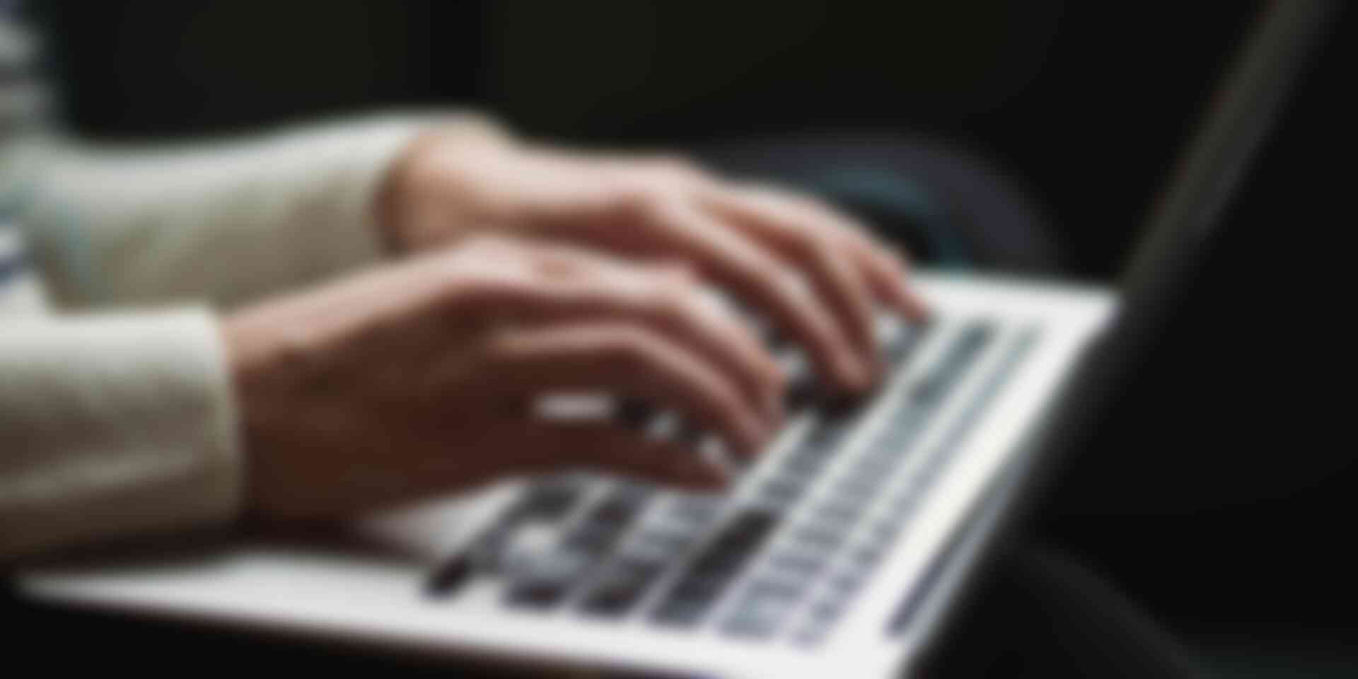 Blog - woman-typing-on-laptop-in-dark
