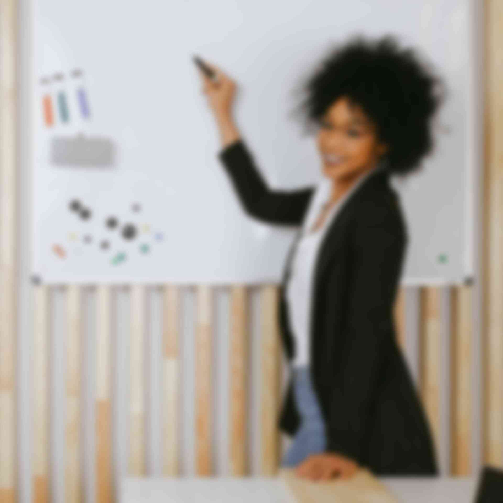 10+1 Tips for Presenters - woman-smiling-writing-on-whiteboard