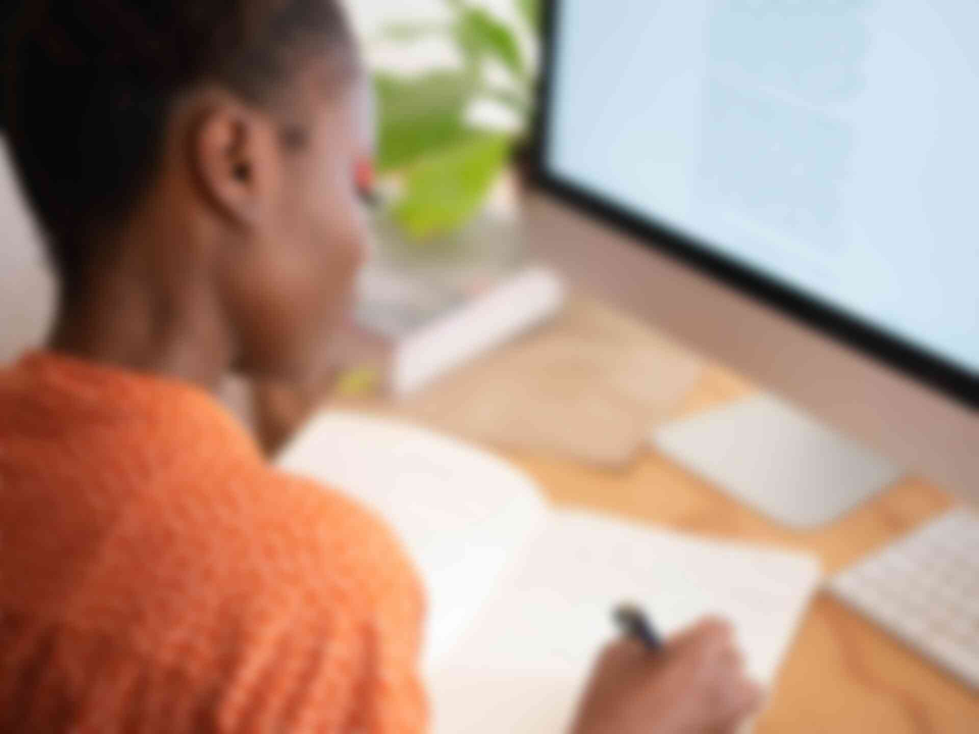 Home - woman-writing-in-front-of-computer