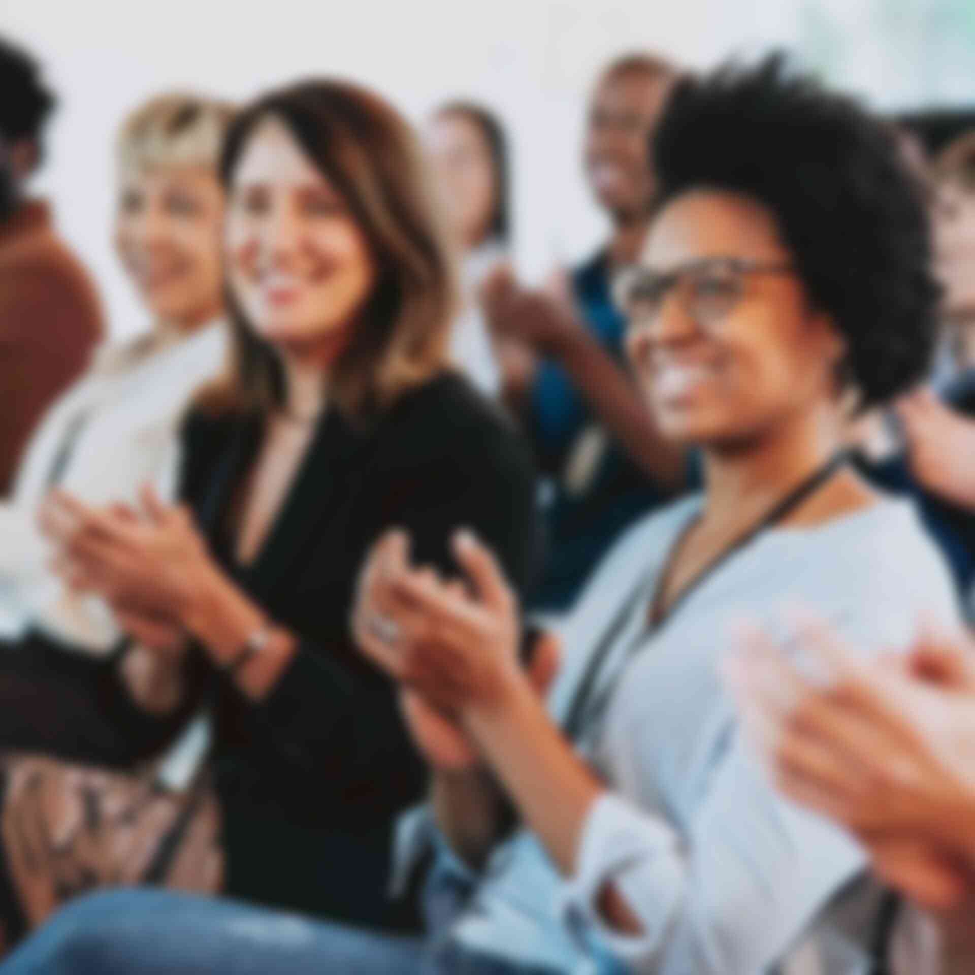 Home - women-clapping-at-presenter